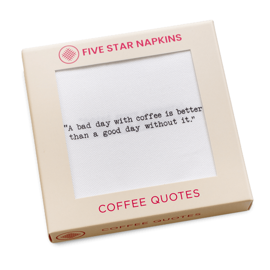 Gift box from Five Star Napkins' Coffee Quotes quote collection, showing an organic cotton cocktail napkin printed with the quote "A bad day with coffee is better than a good day without it"