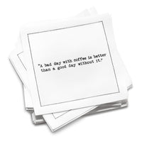 Organic cotton cocktail napkin with a black dotted border printed with the quote "A bad day with coffee is better than a good day without it," from Five Star Napkins' Coffee Quotes quote collection