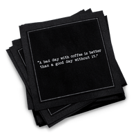 Organic cotton cocktail napkin, black, with white dotted border printed with the quote "A bad day with coffee is better than a good day without it," from Five Star Napkins' Coffee Quotes quote collection
