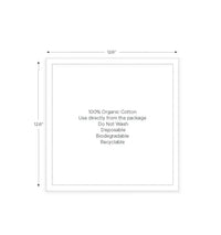 Square organic cotton napkin, 12.6 inches, with printed care instructions at center.