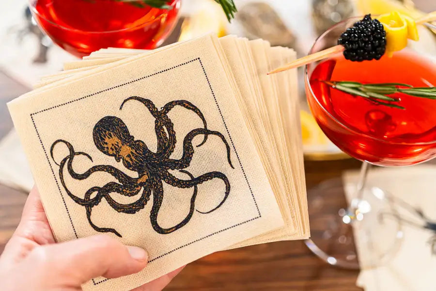 Organic cotton napkin with octopus illustration, styled for a cocktail party setting