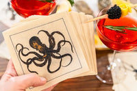 Organic cotton napkin with octopus illustration, styled for a cocktail party setting