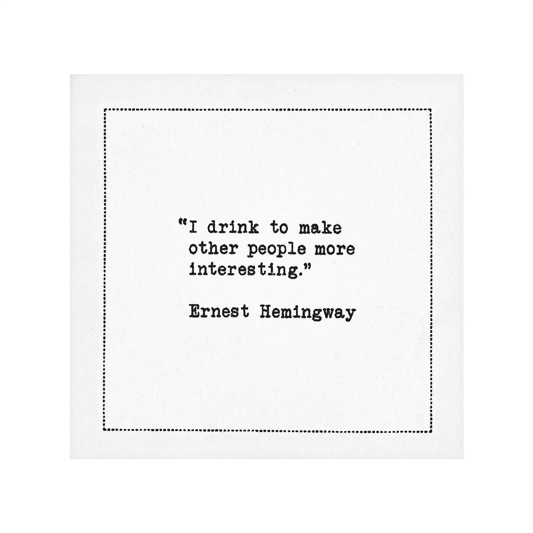 White drinking quote cocktail napkin with black typewriter-style text reading, “I drink to make other people more interesting.” – Ernest Hemingway.