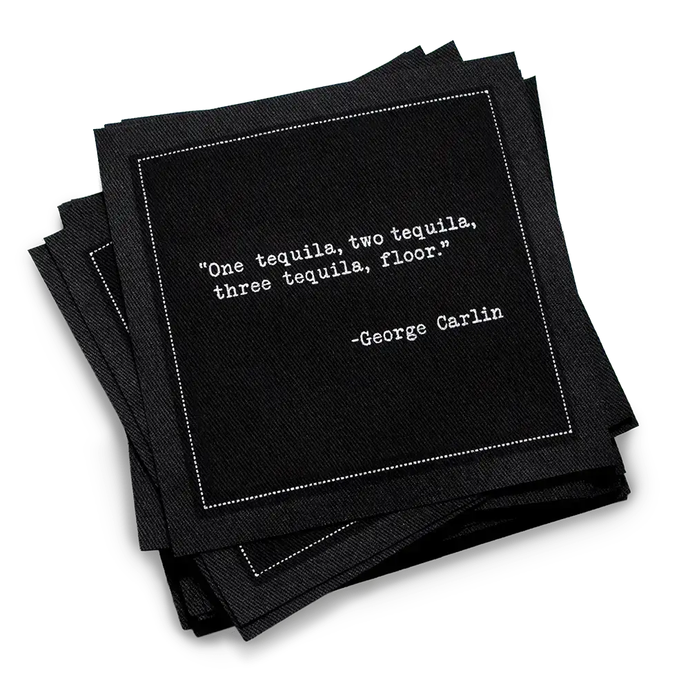 Black cocktail napkins with white typewriter-style text reading, “One tequila, two tequila, three tequila, floor.” – George Carlin.