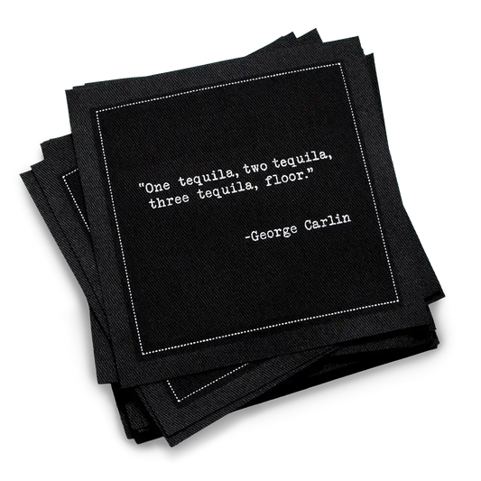 Black cocktail napkins with white typewriter-style text reading, “One tequila, two tequila, three tequila, floor.” – George Carlin.