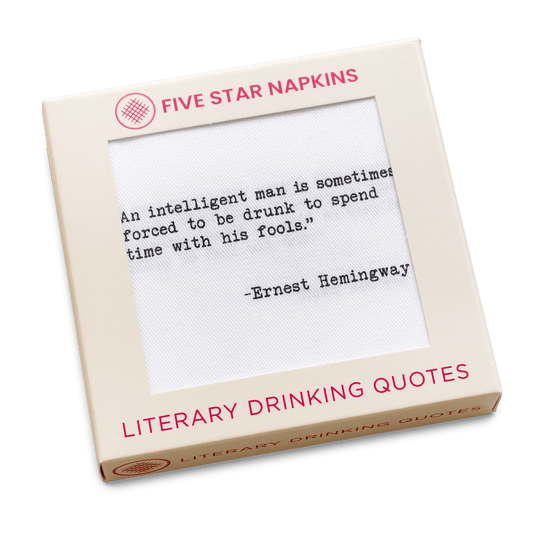 A cream-colored Five Star Napkins box labeled “Literary Drinking Quotes,” with a window showing a white napkin printed with the Ernest Hemingway quote, “An intelligent man is sometimes forced to be drunk to spend time with his fools.”