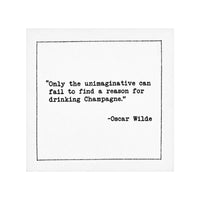 White cocktail napkin with black typewriter-style text reading, “Only the unimaginative can fail to find a reason for drinking Champagne.” – Oscar Wilde.