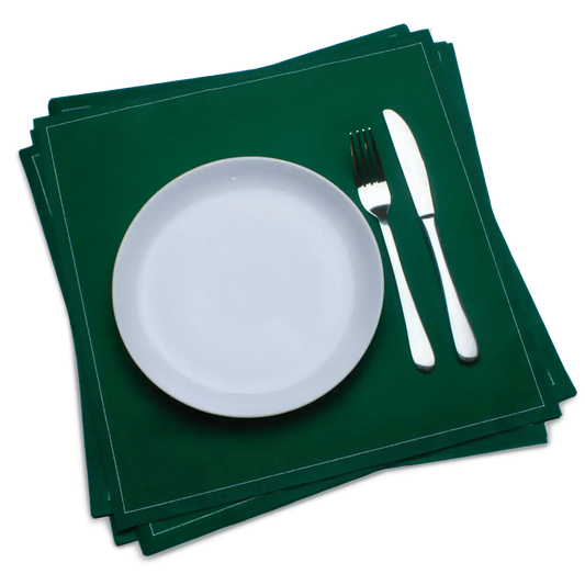 Green luxury cotton dinner napkins with white plate, fork, and knife on top