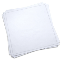 Stack of plain white cotton dinner napkins from Five Star Napkins on green background