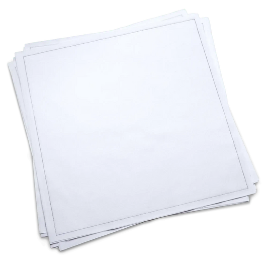 Stack of plain white cotton dinner napkins from Five Star Napkins on green background