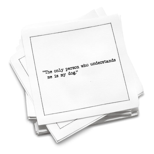 Stack of white organic cotton cocktail napkins with black dotted border printed with the quote “The only person who understands me is my dog,” from Five Star Napkins' Dog quote collection