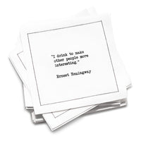Funny white cotton cocktail napkin from The Drinking Quotes First Edition, printed with black typewriter-style text reading, “I drink to make other people more interesting.” – Ernest Hemingway.