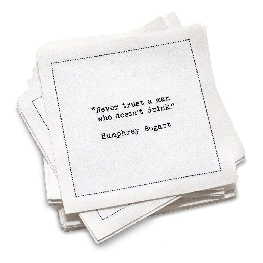 50 white Cotton Cocktail Napkins from The Drinking Quotes First Edition, featuring quotes by famous actors and authors in white typewriter-style text reading, “I love the nights I can’t remember with the friends I can’t forget.” – Unknown Author.