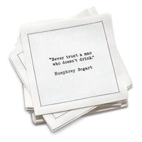 50 white Cotton Cocktail Napkins from The Drinking Quotes First Edition, featuring quotes by famous actors and authors in white typewriter-style text reading, “I love the nights I can’t remember with the friends I can’t forget.” – Unknown Author.