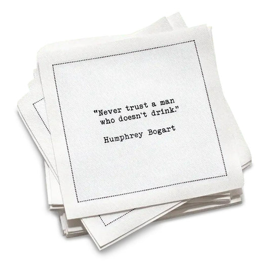 50 white Cotton Cocktail Napkins from The Drinking Quotes First Edition, featuring quotes by famous actors and authors in white typewriter-style text reading, “I love the nights I can’t remember with the friends I can’t forget.” – Unknown Author.