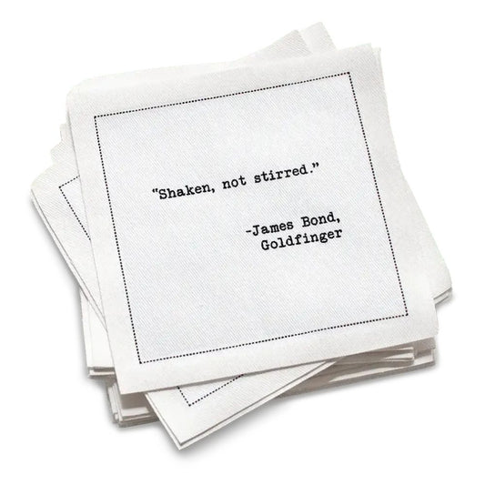 Organic cotton cocktail napkin with black dotted border printed with the quote "Shaken, not stirred," from Five Star Napkins' Drinking Quotes Second Edition collection
