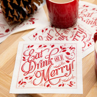 Organic cotton napkin in red Toreador with quote 'Eat, Drink and Be Merry!' on a wooden table