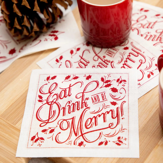 Organic cotton napkin in red Toreador with quote 'Eat, Drink and Be Merry!' on a wooden table