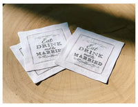 Organic cotton cocktail napkins with printed quote 'Eat Drink and be Married' on table.