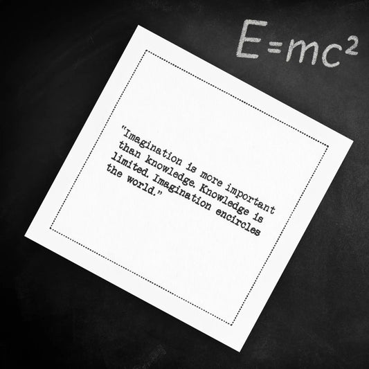 Organic cotton cocktail napkin printed with the quote "Imagination is more important than knowledge. Knowledge is limited. Imagination encircles the world," styled on a chalkboard with the equation E=mc² written above, from Five Star Napkins' Einstein quote collection