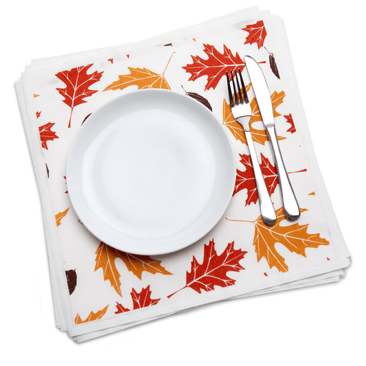 Luxury organic cotton dinner napkin with fall leaf print, plate, and silverware