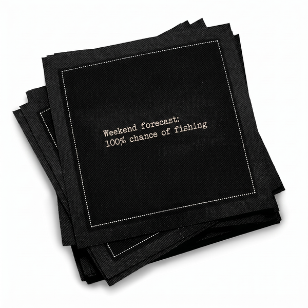Organic cotton cocktail napkin, black, with white dotted border printed with the quote "Weekend forecast: 100% chance of fishing," from Five Star Napkins' Fishing Quote collection