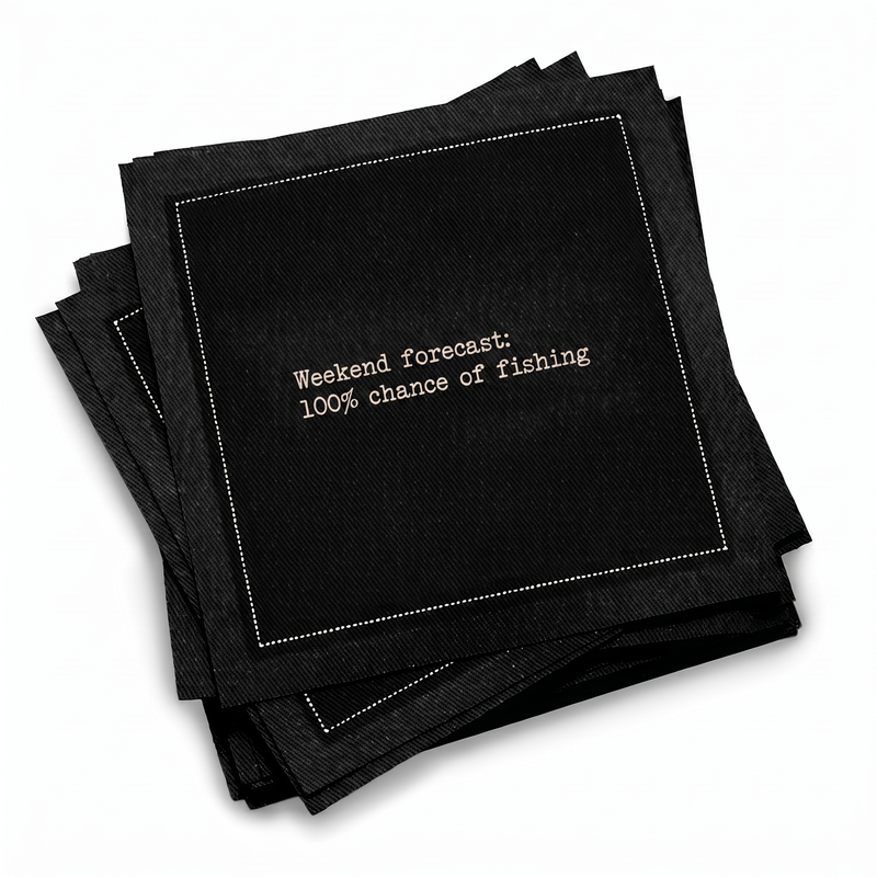 Organic cotton cocktail napkin, black, with white dotted border printed with the quote "Weekend forecast: 100% chance of fishing," from Five Star Napkins' Fishing Quote collection
