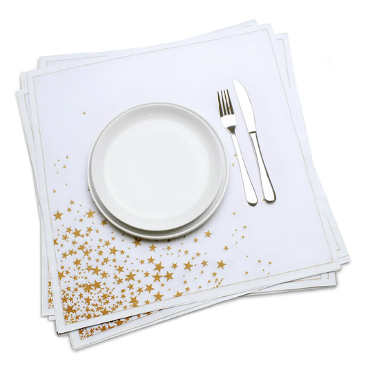 White organic cotton dinner napkin with a gold star print, dressed on a plate with cutlery, by Five Star Napkins.