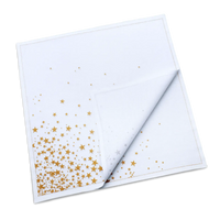 Folded white organic cotton dinner napkin with a gold star print, by Five Star Napkins.