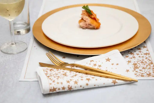 Organic cotton napkin and placemat with gold star pattern at a formal place setting