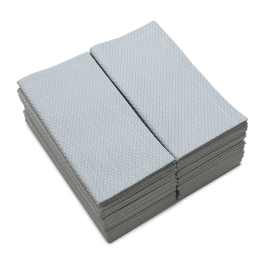 Stack of folded Pearl Grey organic cotton towels with textured pattern