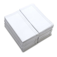 Stack of folded white organic cotton towels with textured pattern