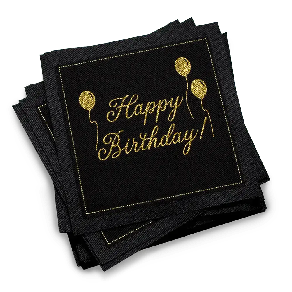 Stack of black organic cotton cocktail napkins with gold “Happy Birthday!” script and balloon design, by Five Star Napkins