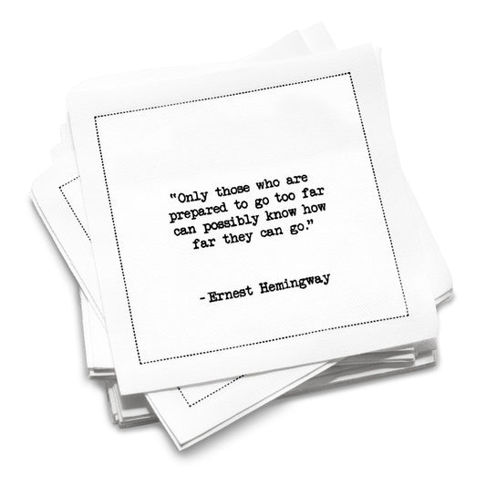 Organic cotton cocktail napkin with black dotted border printed with the quote "Only those who are prepared to go too far can possibly know how far they can go," from Five Star Napkins' Hemingway quote collection