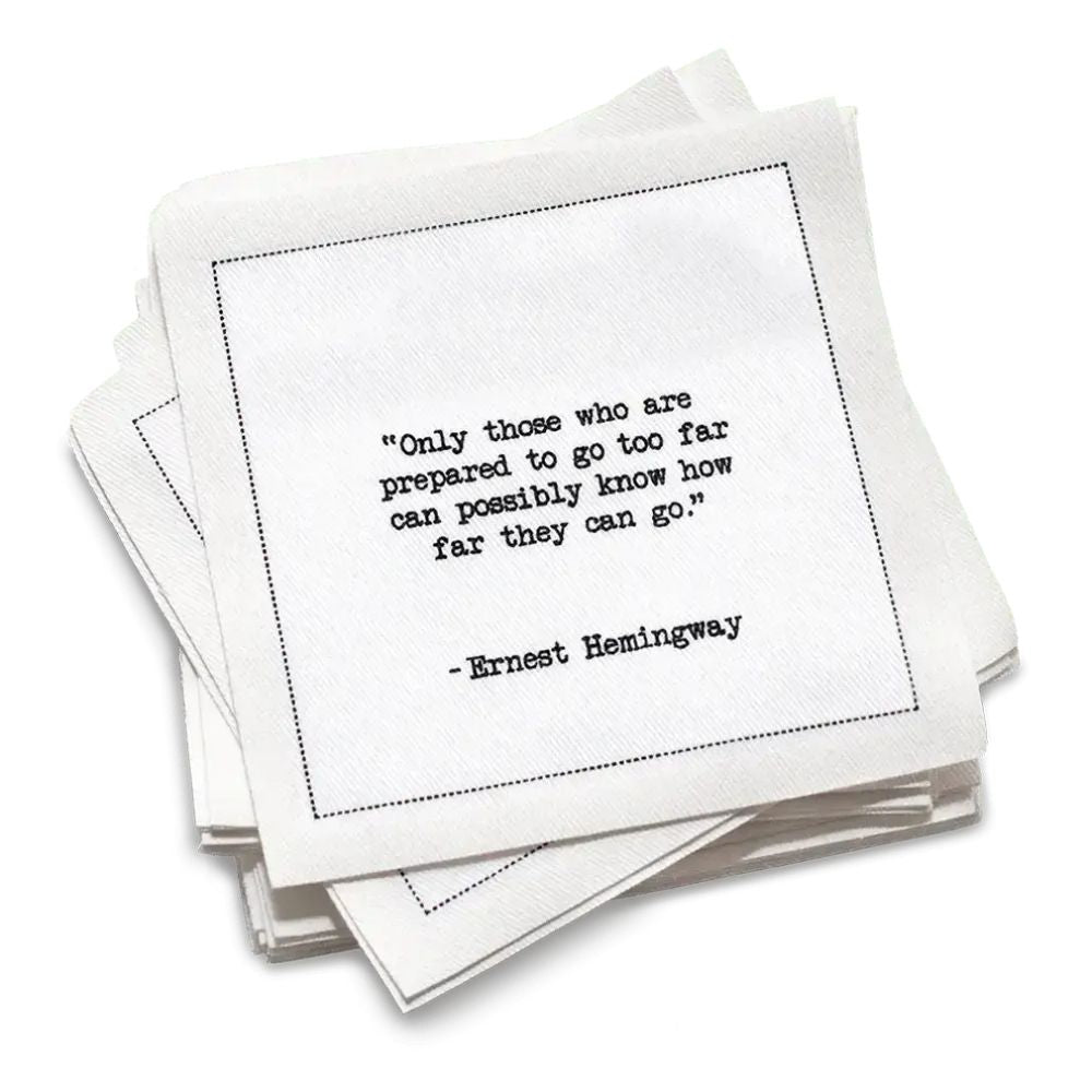 Organic cotton cocktail napkin, white, with black dotted border printed with the quote "Hesitation increases in relation to risk in equal proportion to age," from Five Star Napkins' Hemingway quote collection