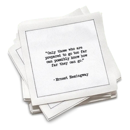 Organic cotton cocktail napkin, white, with black dotted border printed with the quote "Hesitation increases in relation to risk in equal proportion to age," from Five Star Napkins' Hemingway quote collection
