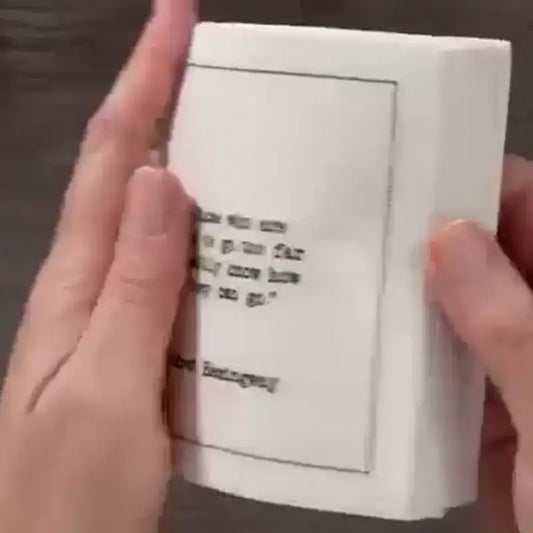 Video of a hand holding a stack of organic cotton cocktail napkins printed with Hemingway quotes, from Five Star Napkins' Hemingway quote collection