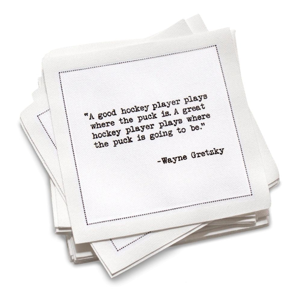 Stack of cotton cocktail napkins with a Wayne Gretzky quote on a white background