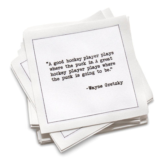 Stack of cotton cocktail napkins with a Wayne Gretzky quote on a white background
