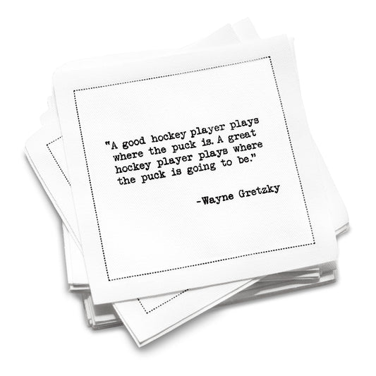Stack of organic cotton cocktail napkins printed with Wayne Gretzky’s “A good hockey player plays where the puck is. A great hockey player plays where the puck is going to be,” from Five Star Napkins’ Hockey Legends quote collection.