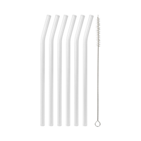 Six clear reusable straws with one cleaning brush on a black background
