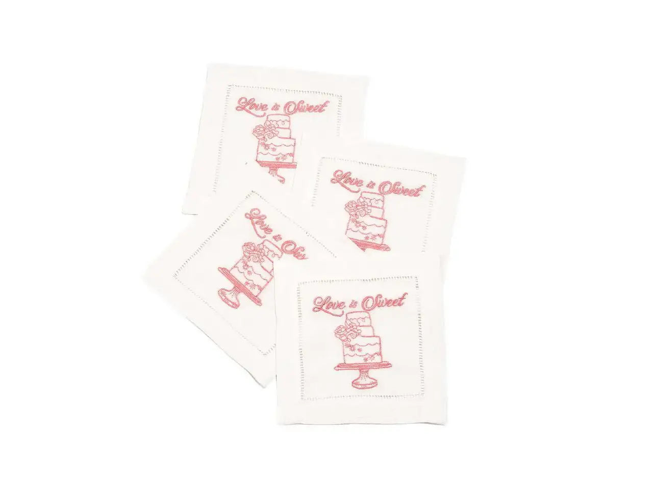 Set of four organic cotton cocktail napkins with 'Love is Sweet' printed quote and cake design.