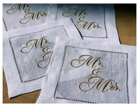 Organic cotton cocktail napkins with gold 'Mr. & Mrs.' quote, white hemstitched design