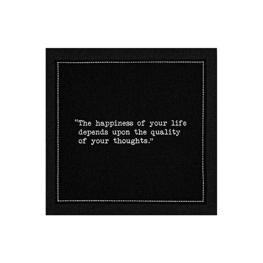 Organic cotton cocktail napkin, black, with white dotted border printed with the quote "The happiness of your life depends upon the quality of your thoughts," from Five Star Napkins' Marcus Aurelius quote collection