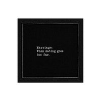 Black marriage quote cocktail napkin with white typewriter-style text reading, “Marriage: When dating goes too far.”