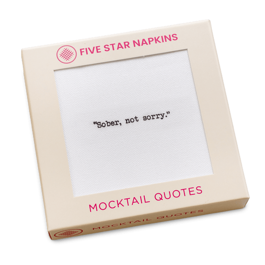 Gift box from Five Star Napkins' Mocktail quote collection, showing an organic cotton cocktail napkin printed with the quote "Sober, not sorry"