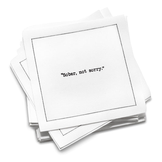 Organic cotton cocktail napkin with black dotted border printed with the quote "Sober, not sorry," from Five Star Napkins' Mocktail quote collection