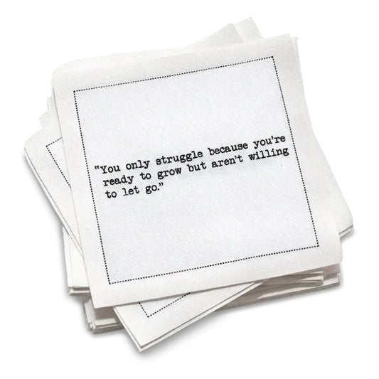 Stack of white cotton cocktail napkins with black text on a white background