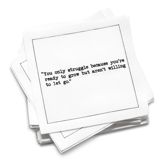 Organic cotton cocktail napkin stack printed with the quote “You only struggle because you’re ready to grow but aren’t willing to let go,” from Five Star Napkins’ Motivational quote collection.