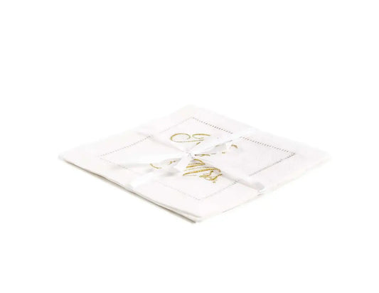 Stack of organic cotton cocktail napkins embroidered with “Mr. & Mrs.” in gold script, tied with a white ribbon, by Five Star Napkins.